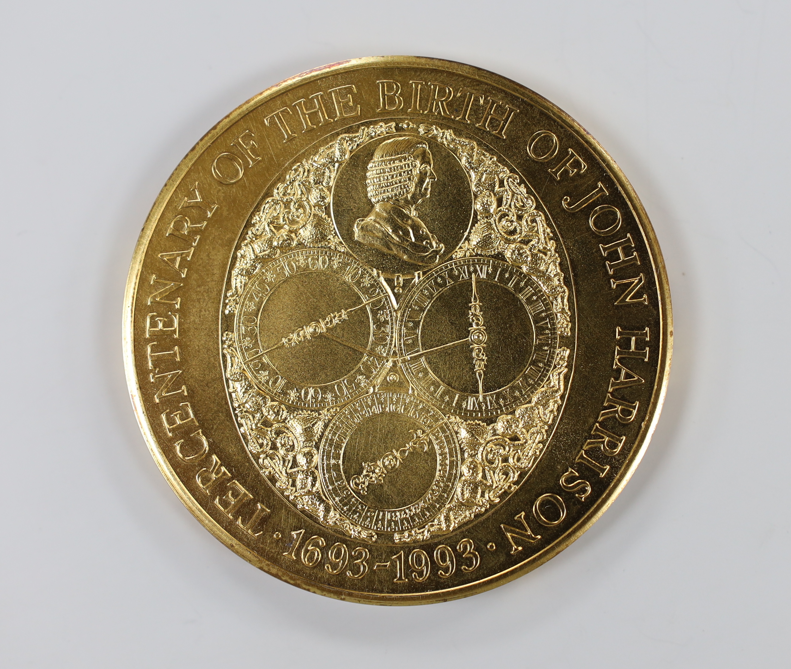 A cased Royal Mint 9ct gold limited edition commemorative gold medal 'Tercentenary of the Birth of John Harrison, 1693-1993', with certificate and paperwork